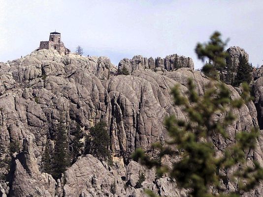 The Harney Peak lookout tower is near Hill City. A U.S. Geological Survey publication titled “Elevations and Distances in the United States” includes a footnote designating Harney Peak as the “Highest summit east of the Rocky Mtns.”