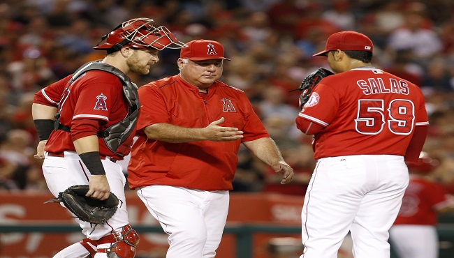 Los Angeles Angels manager Mike Scioscia takes relief pitcher Fernando Salas right out of the baseball game as catcher Jett Bandy left watches during the fifth inning against the Boston Red Sox in Anaheim Calif. Saturday