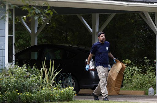 A Mississippi Bureau of Investigation agent takes a bag with evidence from the Durant Miss. home of two slain Catholic nuns who worked as nurses at the Lexington Medical Clinic to his vehicle Thursday Aug. 25 2016. The clinic office manager and a Du