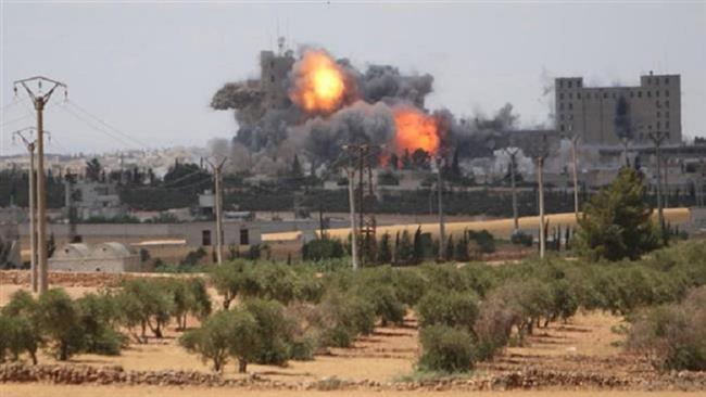 Smoke and flame rise after US-led airstrikes on the city of Manbij in Aleppo province