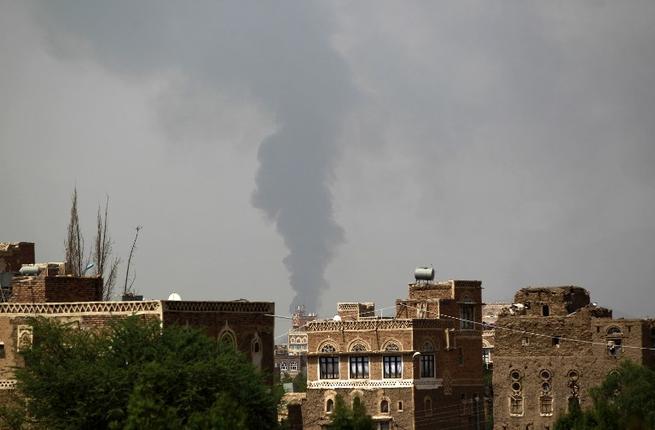 Smoke billows from a building hit by a Saudi-coalition airstrike