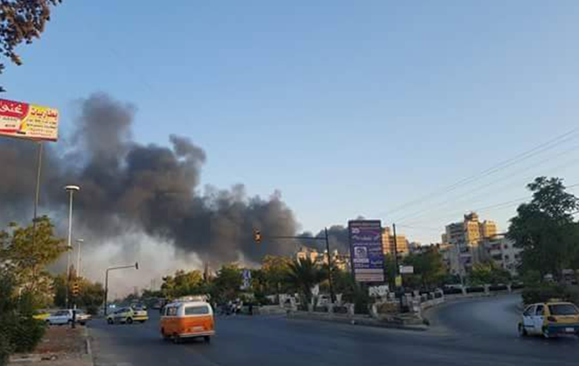 Smoke rises over regime-held al Hamdaniyah on Wednesday after a reported rocket strike