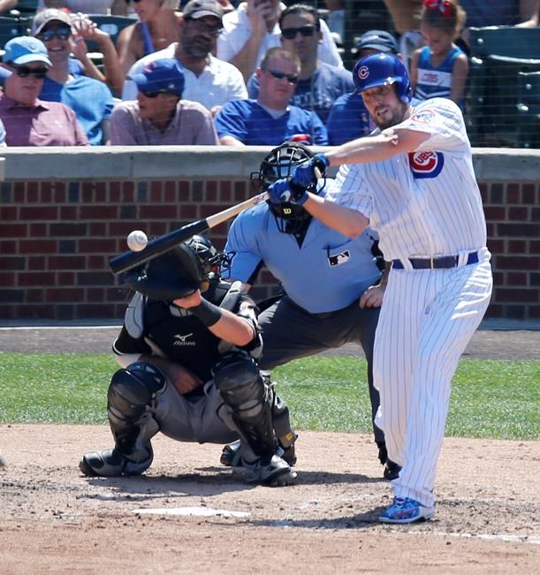 Chicago Cubs&#39 John Lackey hits his second double of the day off Miami Marlins starting pitcher Tom Koehler as catcher Jeff Mathis and umpire Marty Foster watch during the fifth inning of a baseball game Wednesday Aug. 3 2016 in Chicago. (AP