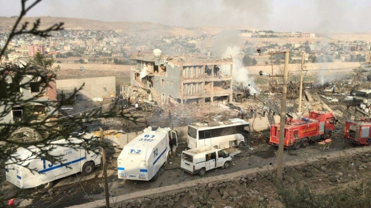 Turkish police and firefighters at the site of the attack against a police barracks in Cizre