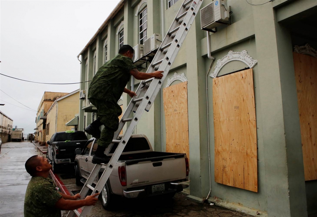 Image Soldiers board up windows in Belize City ahead of Hurricane Earl