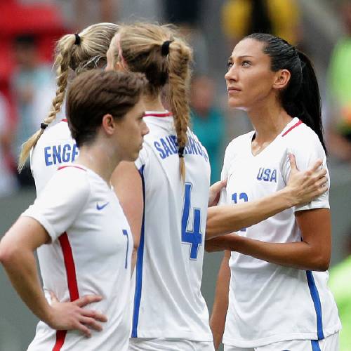 Christen Press is comforted by a teammate after missing a penalty kick during a penalty shoot-out against Sweden at a quarter-final match of the women's Olympic football tournament in Brasilia Friday Aug. 12 2016. The Uni