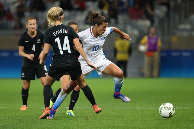 United States&#39 Carli Lloyd center and New Zealand's Katie Bowen 14 vie for the ball during a Women's Olympic Football Tournament match at the Mineirao stadium in Belo Horizonte Brazil Wednesday Aug. 3 2016