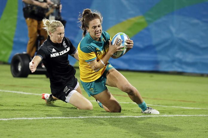 Australia's Evania Pelite right scores a try past New Zealand's Kelly Brazier during the women's rugby sevens gold medal match at the Summer Olympics in Rio de Janeiro Brazil Monday Aug. 8