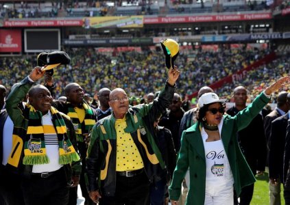 African National Congress president Jacob Zuma waves to his supporters next to his deputy Cyril Ramaphosa as they arrive for the parties traditional Siyanqoba rally ahead of the August 3 local municipal elections in Johannesburg South Afri