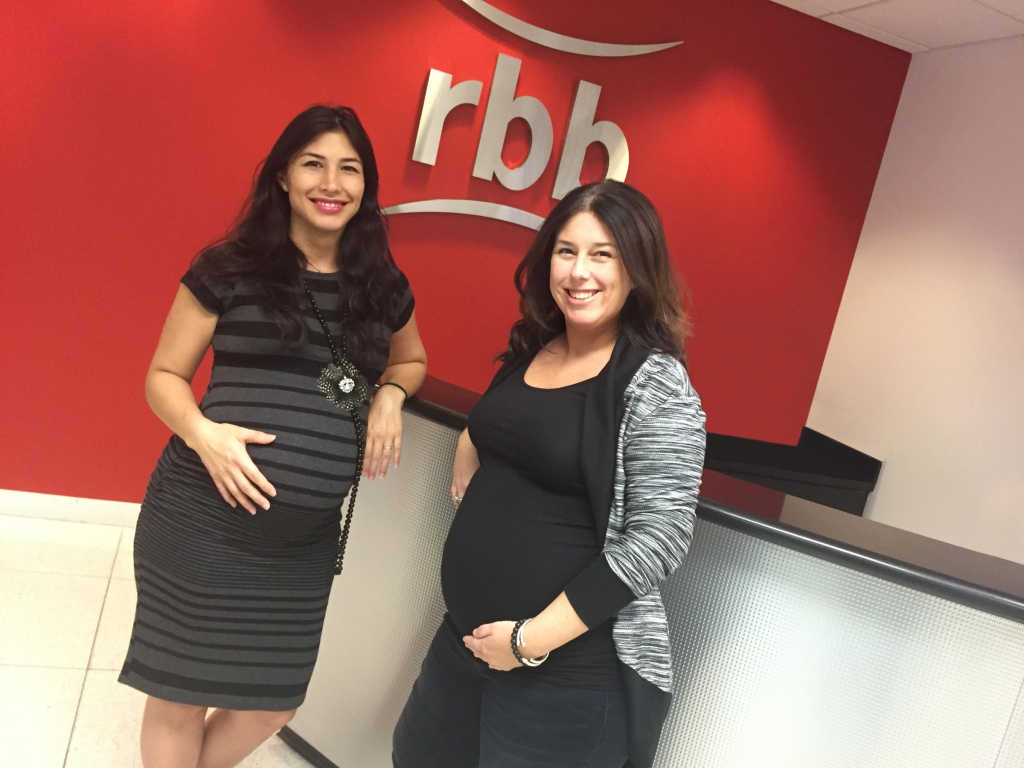 Showing off their baby bumps Zonnia Knight and Susie Gilden work together at rbb Communications in Coral Gables