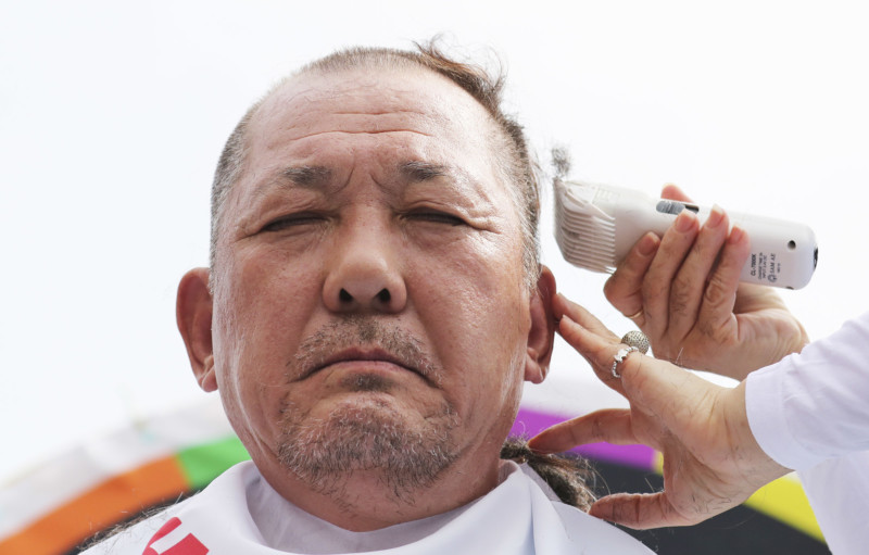 Kim Hang-gon has his head shaved during a protest against a plan to deploy an advanced U.S. missile defense system in their neighborhood in Seoul South Korea Thursday