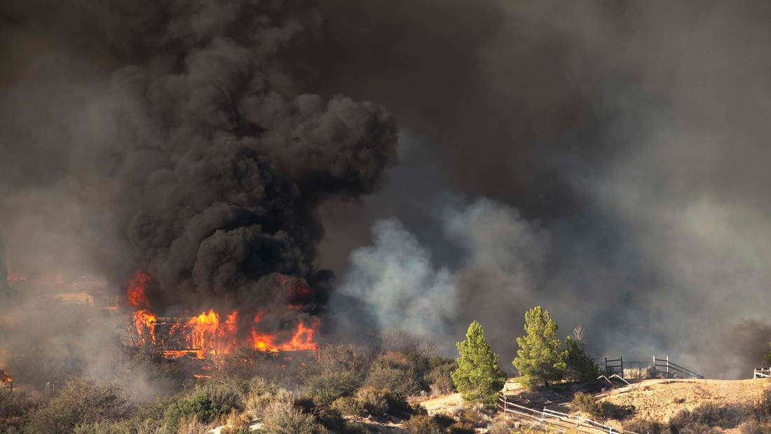 A home is engulfed in flames as the Blue Cut fire burns out of control on both sides of Highway 138 in Summit Valley California