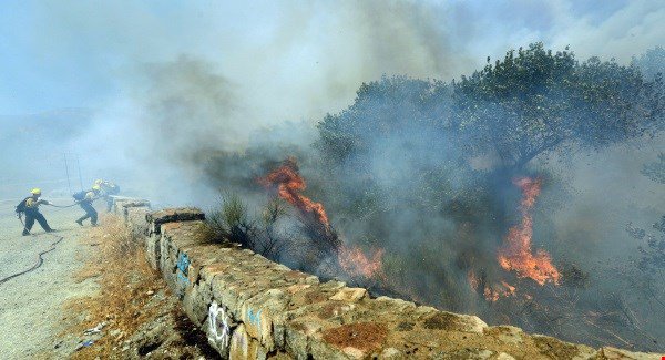 The Latest: Blaze that decimated town 35 percent contained