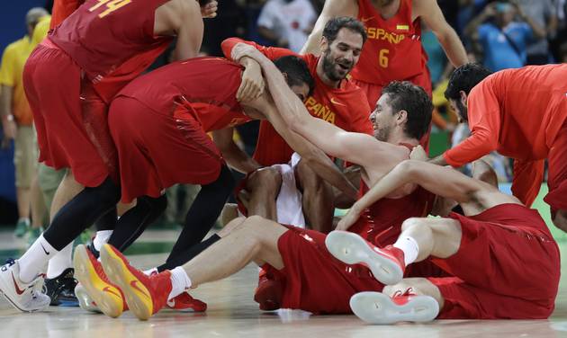 Spain's Pau Gasol center falls to th floor as he celebrates with teammates after their win over Australia a men's bronze medal basketball game at the 2016 Summer Olympics in Rio de Janeiro Brazil Sunday Aug. 21 2016