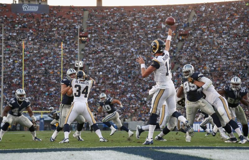 Quarterback Sean Mannion of the Los Angeles Rams throws a pass against the Dallas Cowboys during their NFL game at the Los Angeles Coliseum