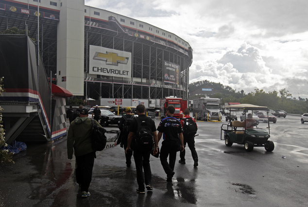 Crew members make their way into Bristol Motor Speedway under threatening skies for a NASCAR Sprint Cup Series auto race Sunday Aug. 21 2016 in Bristol