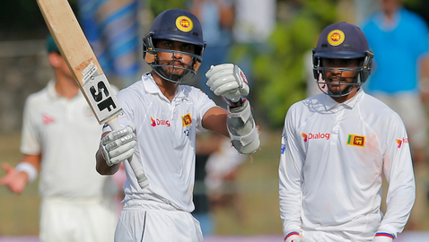 Sri Lanka's Dinesh Chandimal celebrates a half century during his 188-run partnership with Dhananjaya de Silva