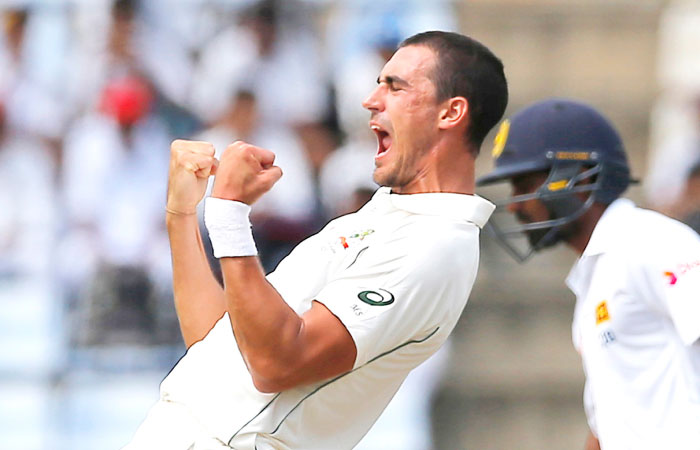 Australian bowler Mitchell Starc celebrates after taking the wicket of Sri Lanka’s Dimuth Karunaratne on the first day of the first Test cricket match in Pallekele Sri Lanka Tuesday. — AP