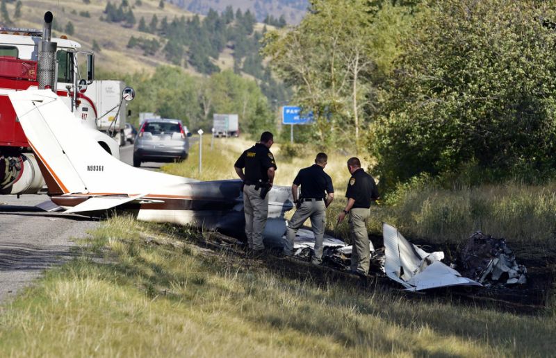 Missoula County sheriff's deputies look at the wreckage of a Cessna 182 that crashed on the shoulder of Interstate 90 near Rock Creekont. on Sunday Aug. 28 2016. The crash killed 52-year-old Darrell Ward of Deer Lodge a star of the History channe