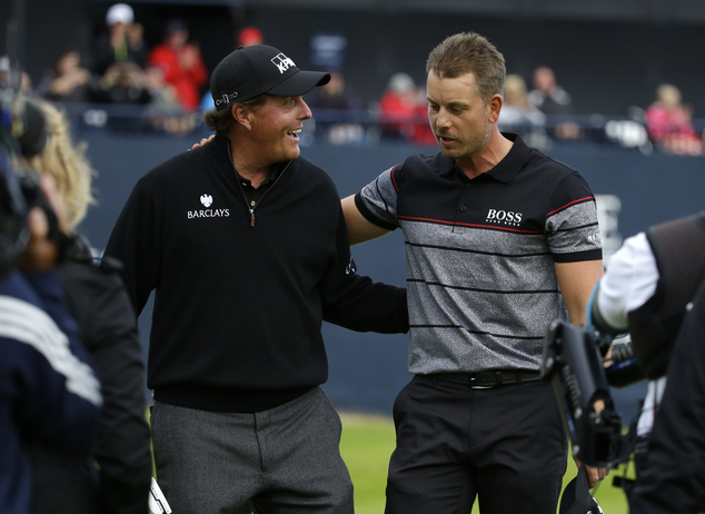 Phil Mickelson of the United States left congratulates Henrik Stenson of Sweden for winning the British Open Golf Championships at the Royal Troon Golf Club