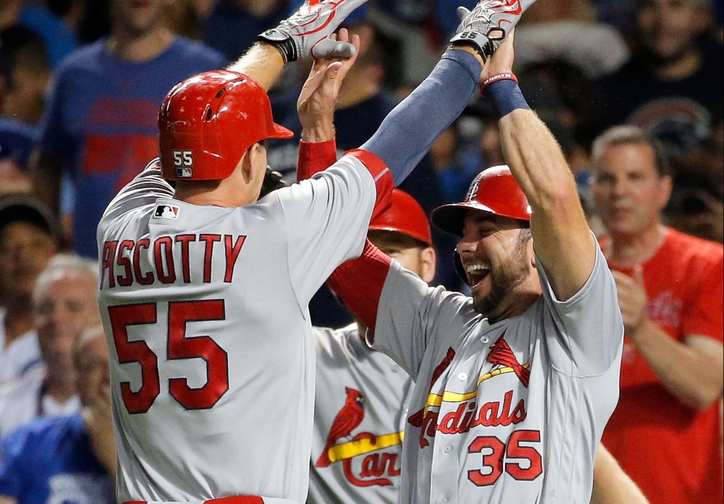 Stephen Piscotty is greeted by Cardinals teammate Greg Garcia after homering against the Cubs