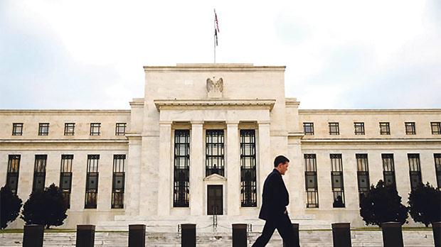 A man walks past the Federal Reserve Bank in Washington DC