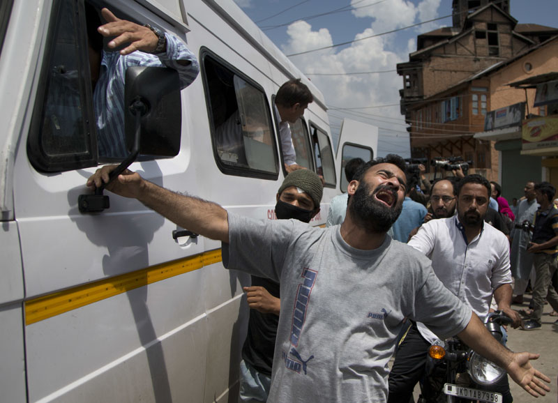 An unidentified relative of Riyaz Ahmad Shah one among two civilians killed by government forces wails as an ambulance carrying his body arrives at his home in Srinagar,on Wednesday Aug. 3 2016