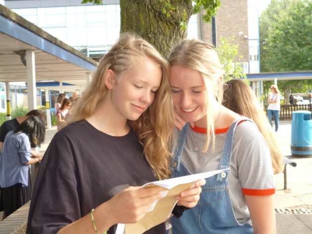 Student Emily Burton reading her results with Emily Noon from the John Henry Newman School