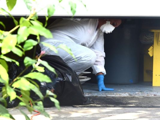 Employees with Accident Scene Cleaners of Port St. Lucie work Wednesday inside the garage of the Martin County Fla. home where John Stevens III and Michelle Mishcon were killed Aug. 15 2016. News