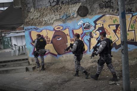 Brazil's national security force officers move inside the Vila do Joao part of the Mare complex of slums during a police operation in search for criminals during the 2016 Summer Olympics in Rio de Janeiro Brazil Thursday Aug. 11 2016. A police