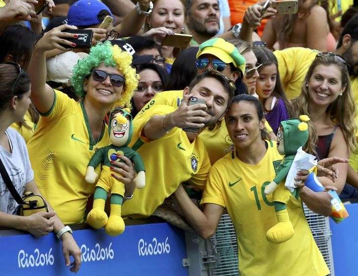 2016 Rio Olympics- Soccer- Semifinal- Women's Football Tournament Semifinal Brazil v Sweden- Maracana- Rio de Janeiro Brazil- 16/08/2016. Marta of Brazil takes a selfie with fans after her team was defeated by Sweden. REUTERS  Leonhard Foeger