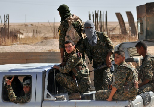 AFP  File  Delil Souleiman
Fighters from the Kurdish People's Protection Units sit in the back of a vehicle in the al Zohour neighbourhood of the northeastern Syrian city of Hasakeh