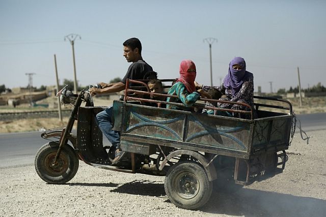 Syrian Kurdish civilians flee reported shelling in the northeastern governorate of Hasakah