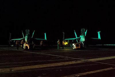 Sailors prepare to secure two F  A-18E Super Hornets to the flight deck of the aircraft carrier USS Dwight D. Eisenhower in the Persian Gulf