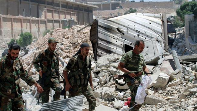 Syrian state news agency SANA shows government forces walking with their weapons past rubble after they advanced on the southern side of the Castello Road in Aleppo