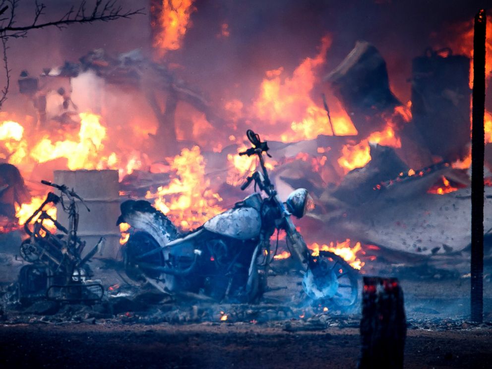 TNS via Getty Images A motorcycle burns near a structure during the Clayton Fire in Lower Lake California on Aug. 14 2016