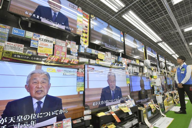 TV sets showing Japanese Emperor Akihito's address are seen at an electronic shop in Tokyo Japan in this