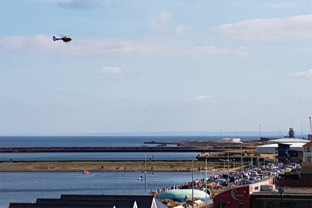 A helicopter flies above Sunderland Harbour