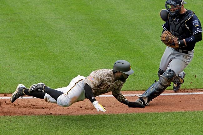 Pittsburgh Pirates&#39 Josh Harrison bottom tries unsuccessfully to get around San Diego Padres catcher Derek Norris after being caught in a rundown between third and home in the fourth inning a baseball game in Pittsburgh Thursday Aug. 11 2016. (AP