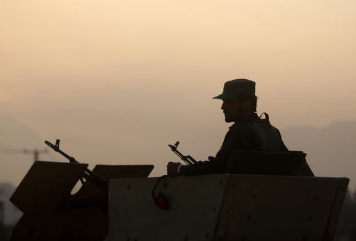 An Afghan policeman guards on a road leading to the site of an explosion in Kabul Afghanistan Monday Aug. 1 2016. A strong explosion took place early Monday near a guesthouse for foreigners in Kabul an Afghan police