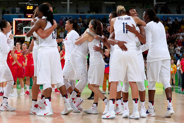 RIO DE JANEIRO BRAZIL- AUGUST 20 Sylvia Fowles #13 Sue Bird #6 Elena Delle Donne #11 and Angel Mccoughtry #8 of United States celebrate winning the Women's Gold Medal Game between United States and Spain on Day 15 of the Rio 2016 Olympic Games