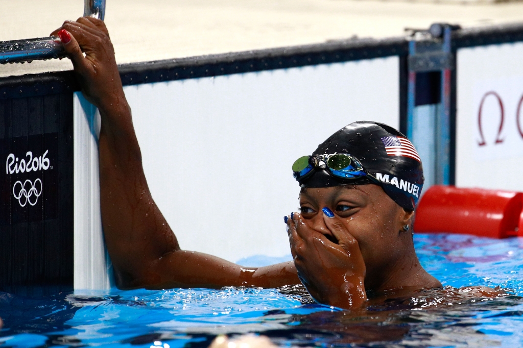 RIO DE JANEIRO BRAZIL- AUGUST 11 Simone Manuel of the United States celebrates after winning gold in the Women's 100m Freestyle Final on Day 6 of the Rio 2016 Olympic Games at the Olympic Aquatics Stadium