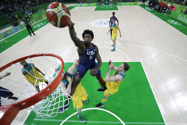 United States De Andre Jordan drives to the basket over Australia's Aron Baynes left and Cameron Bairstow right during a basketball game at the 2016