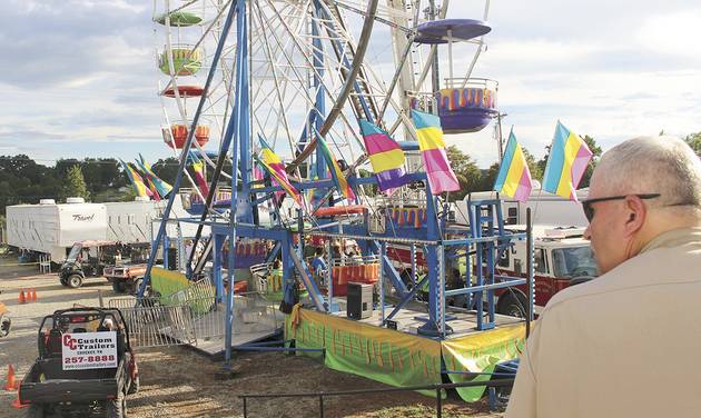 Law enforcement cordon off the area surrounding the Ferris wheel Monday Aug. 8 2016 after three people fell from the ride during a county fair in Greenville Tenn. Baileyton police Officer Kenneth Bitner is visible at right. Police say one of three peo