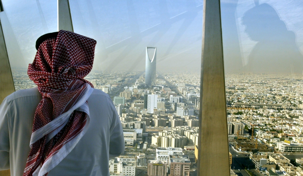 A man looks at central Riyadh from the Faisaliah Tower- Saudi Arabia