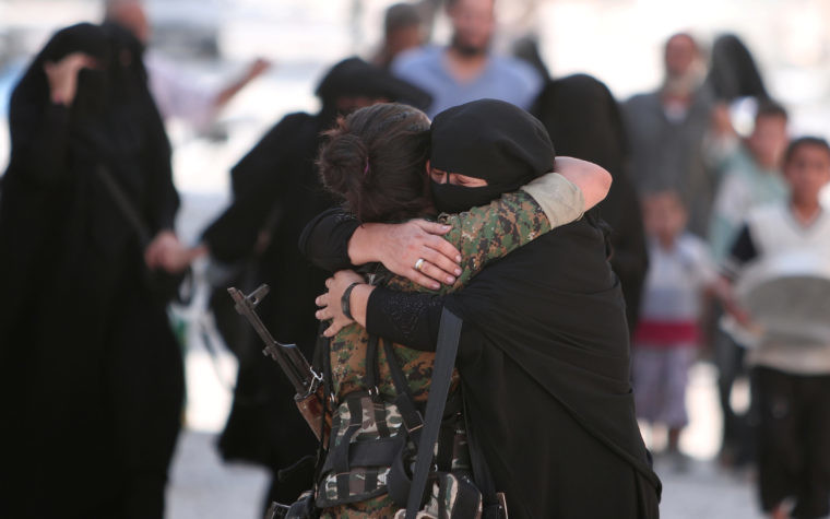 A woman embraces a Syria Democratic Forces fighter after she was evacuated from an Islamic State-controlled neighbourhood of Manbij