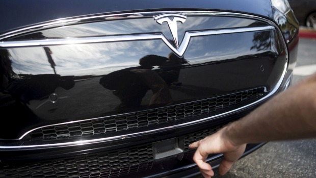 The radar technology of a Tesla Model S containing Autopilot features is pointed out during a Tesla event in Palo Alto