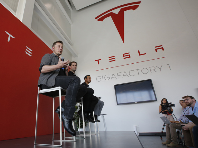 Elon Musk CEO of Tesla Motors Inc. left discusses the company's new Gigafactory in Sparks Nev. On Wedn