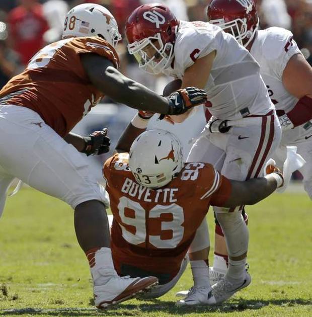 Texas Hassan Ridgeway and Paul Boyette Jr. bring down OU quarterback Baker Mayfield in the Cotton Bowl last October