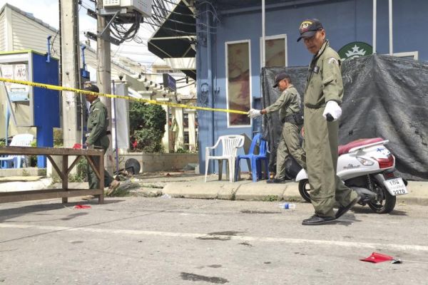 Investigators work at the scene of an explosion